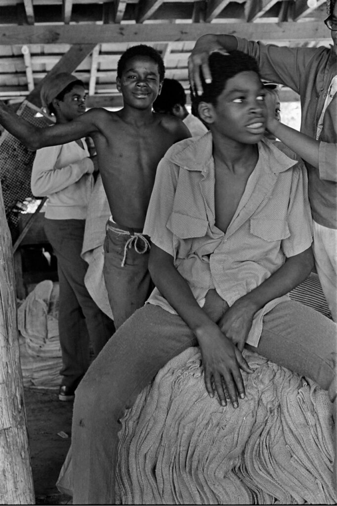 Men sitting in farm shed
